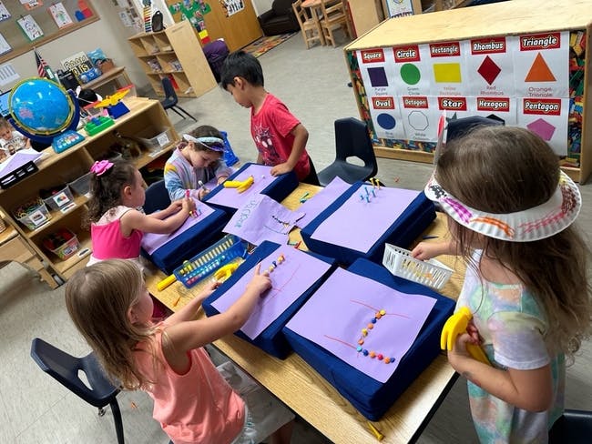 Children working on art projects in a classroom