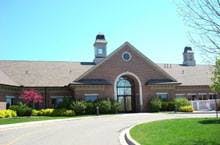 Brick building with a large arched entrance and cupolas