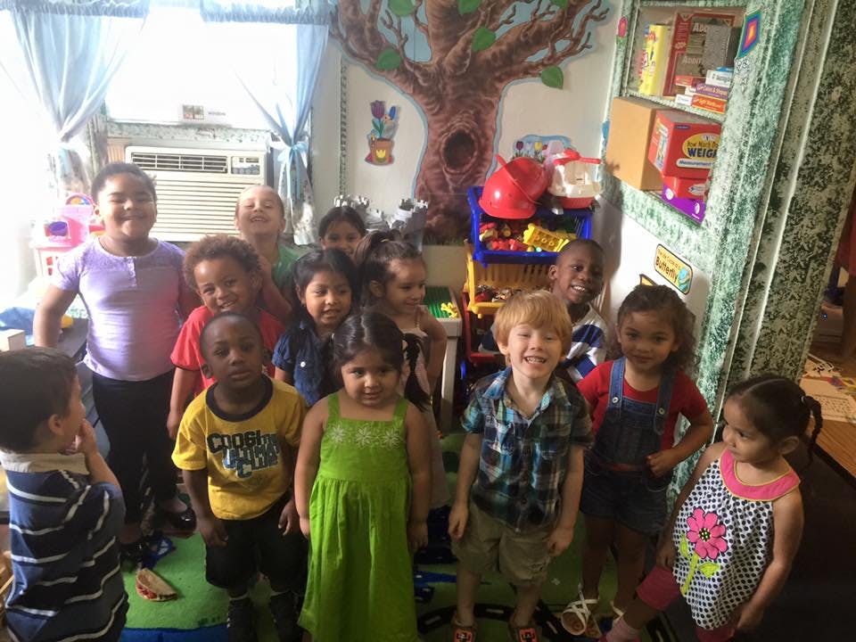 Group of children standing in a classroom