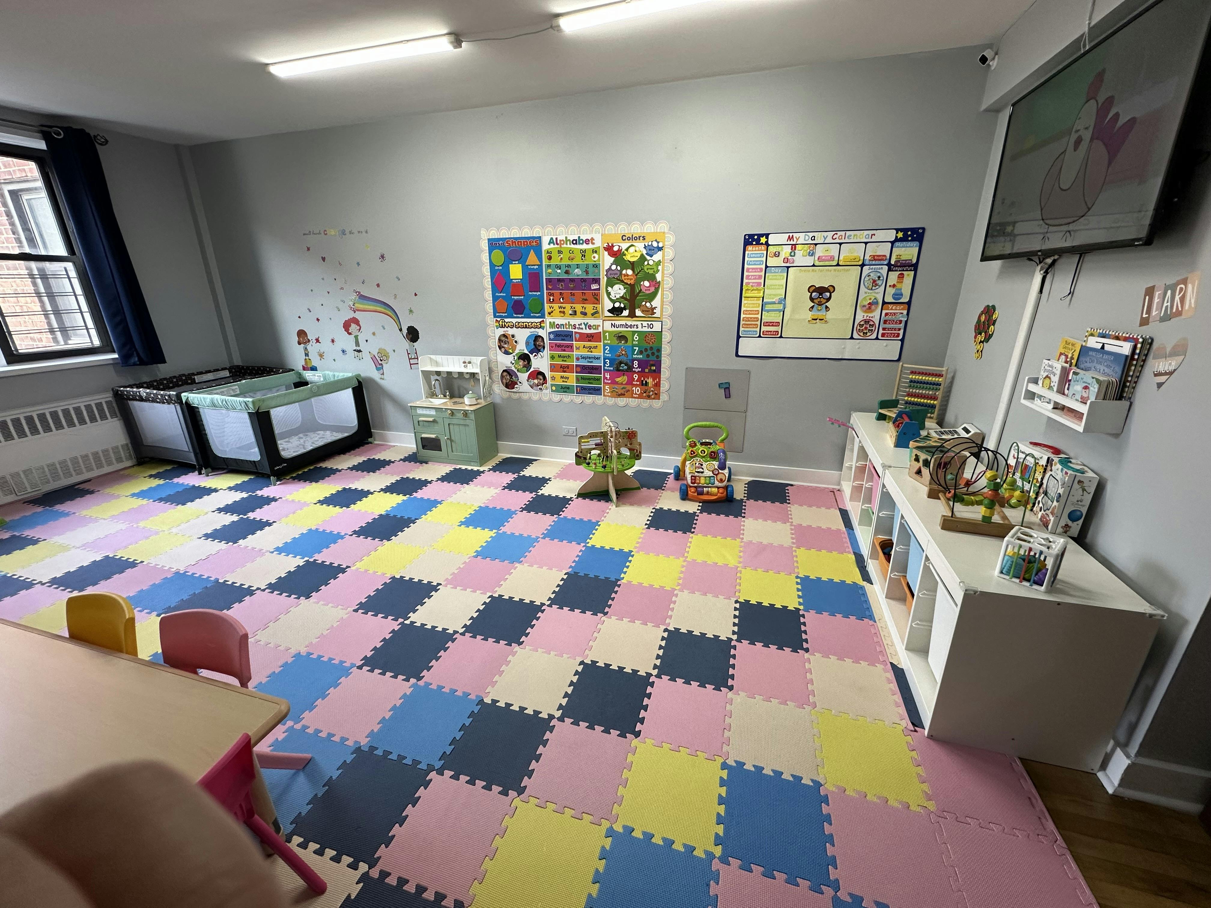 Playroom with colorful checkered floor, cribs, and shelves with toys