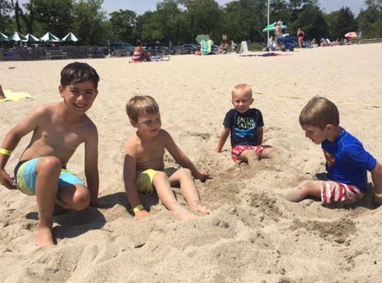 Four children playing in the sand on a beach