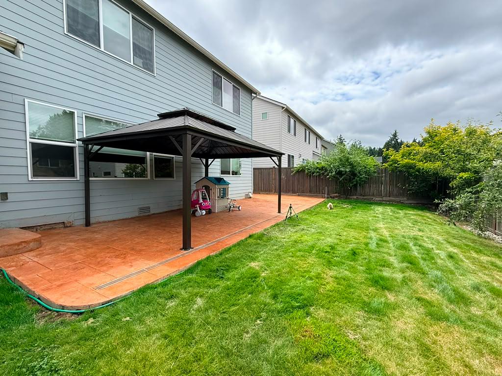 Gazebo on a stamped concrete patio in a residential backyard