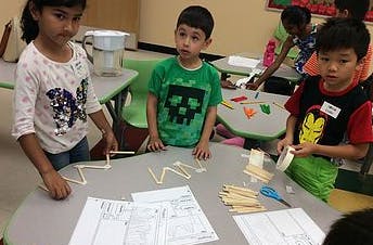Children working on a craft project at a table