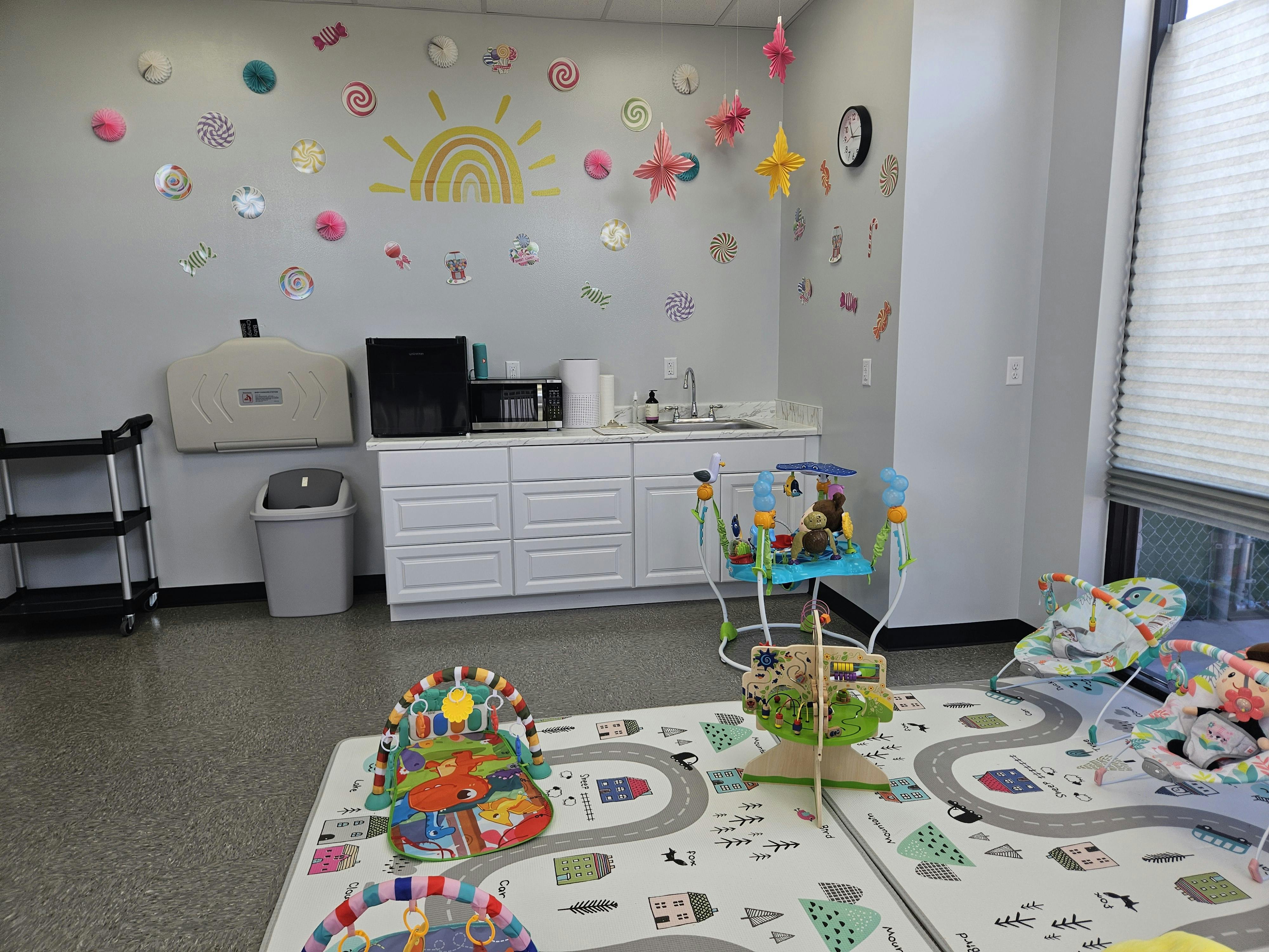 Playroom with baby activity centers and changing station