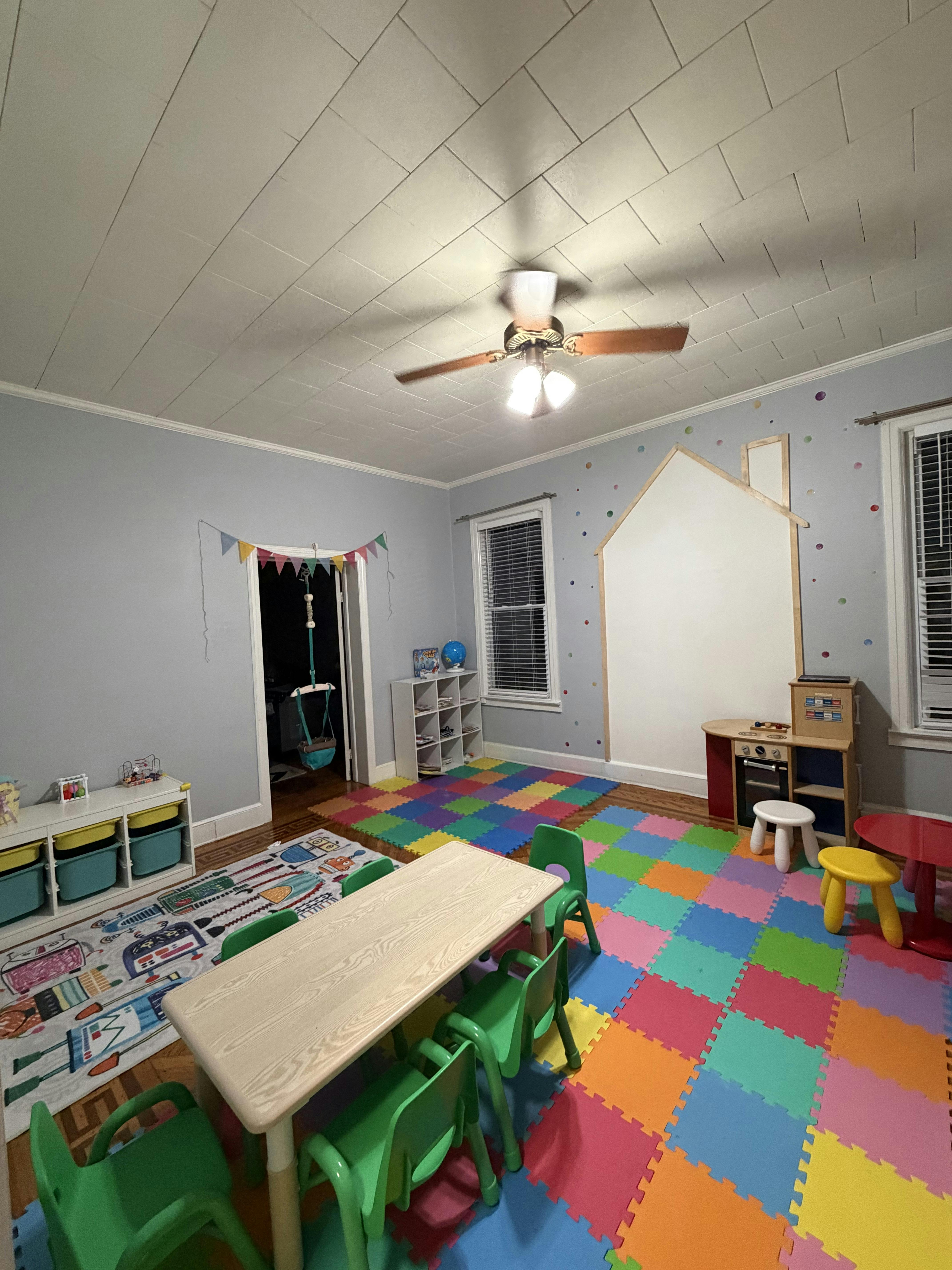 Playroom with children's furniture and colorful floor mats
