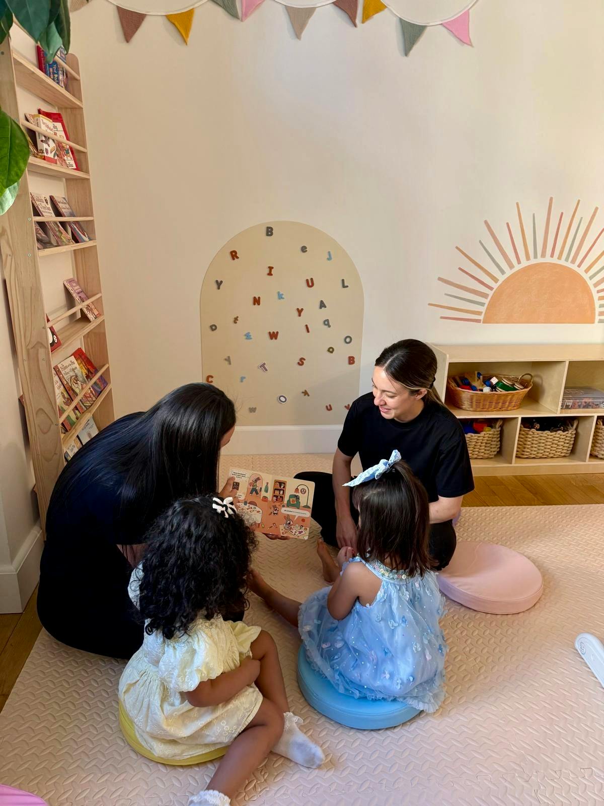 People reading a book together in a playroom