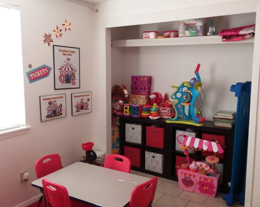 Playroom with a small table and chairs, and shelves filled with toys