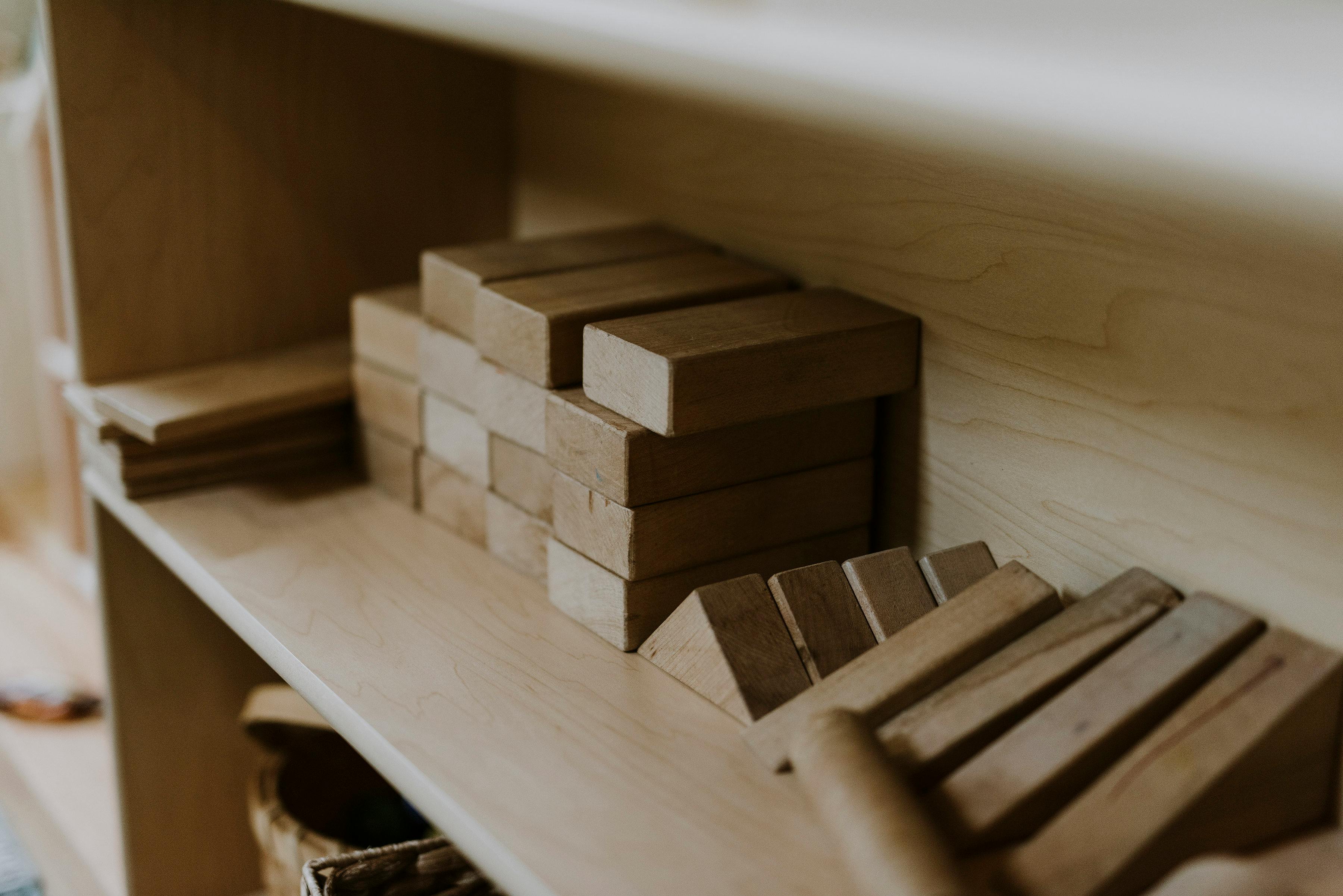 Wooden blocks and triangular pieces on a shelf