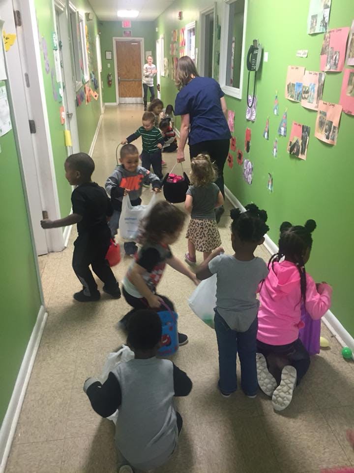 Adult and children in a hallway