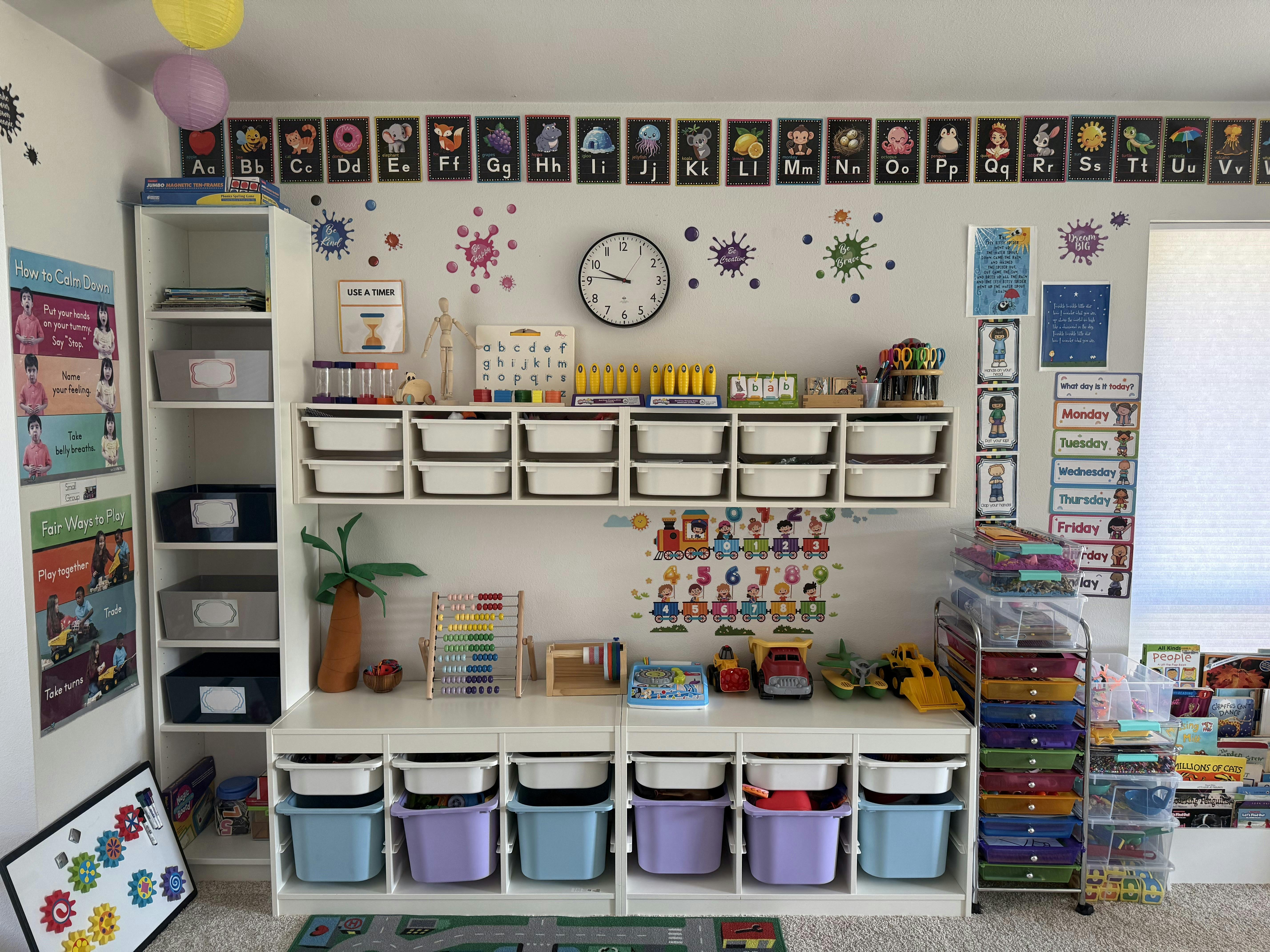 Classroom interior with educational wall charts and organized toy storage units