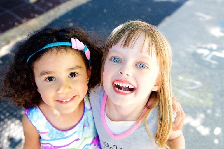 Two children smiling at the camera