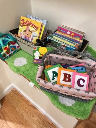 Children's books in boxes and alphabet blocks in a basket