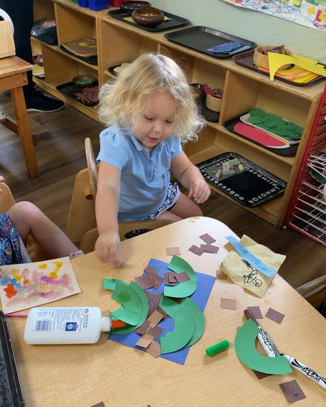 Child doing an art project at a table