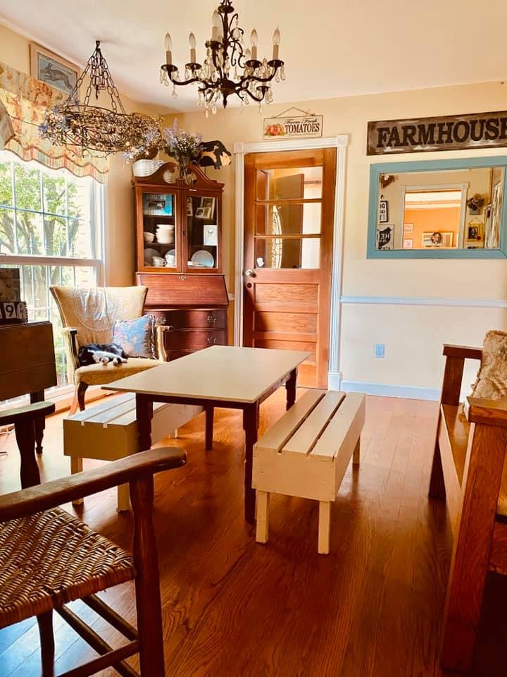 Dining room with wooden table, benches, and chairs
