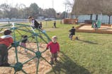 Children playing on a climbing dome at a playground