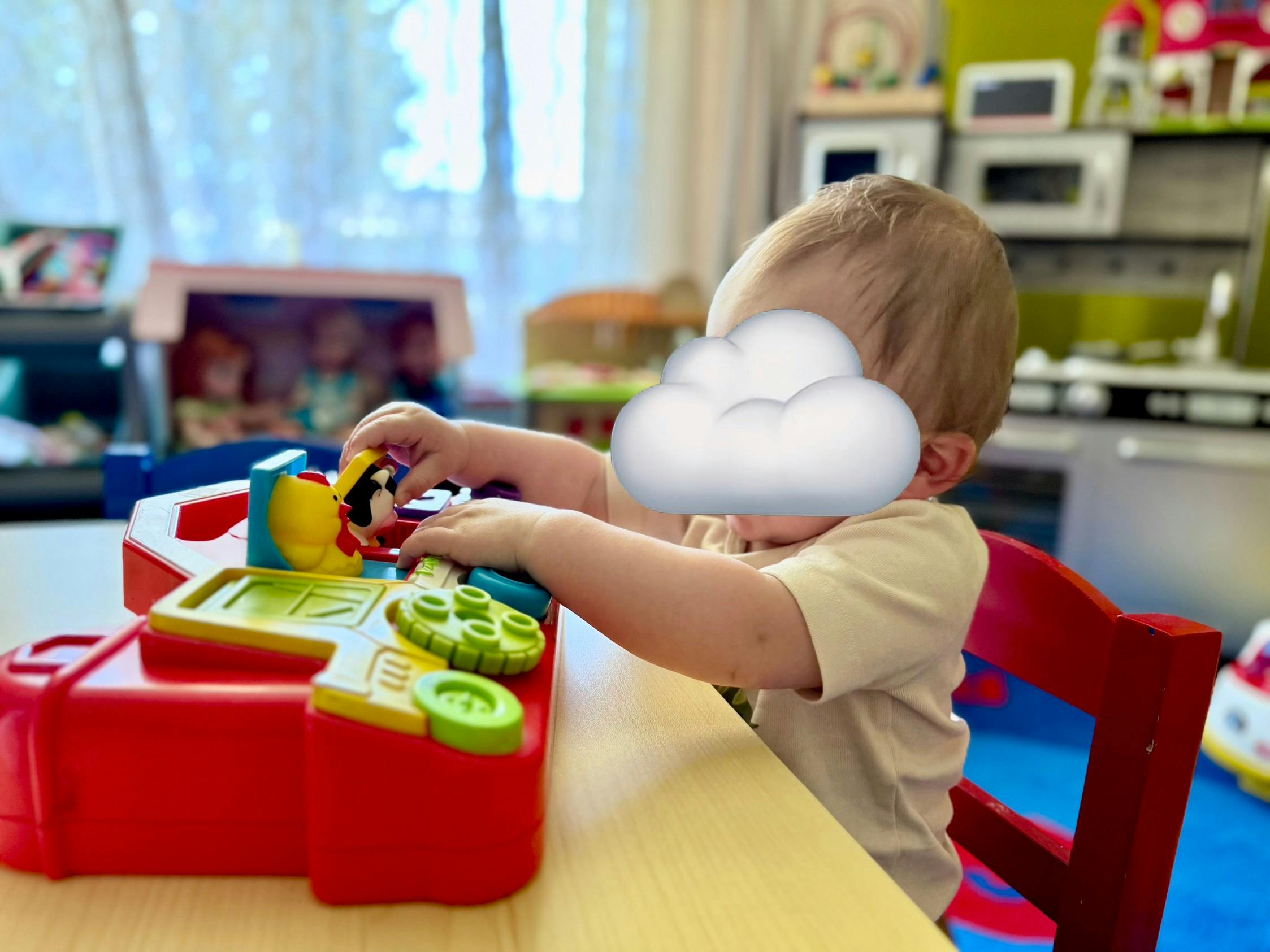 Child playing with a colorful toy on a table