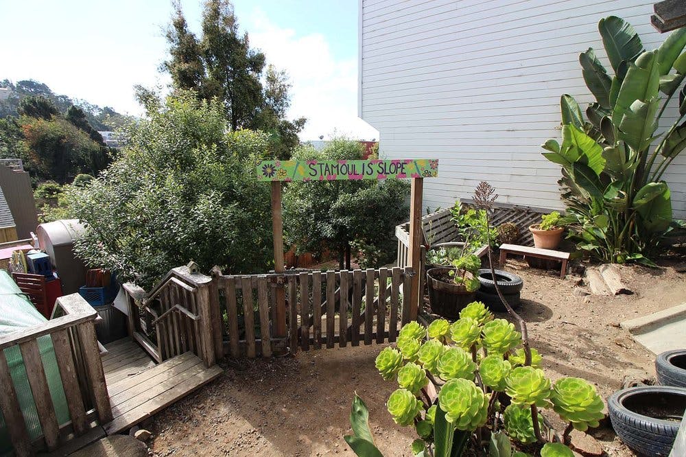 Wooden fence and gate with a sign that reads "Sunshine Suite"