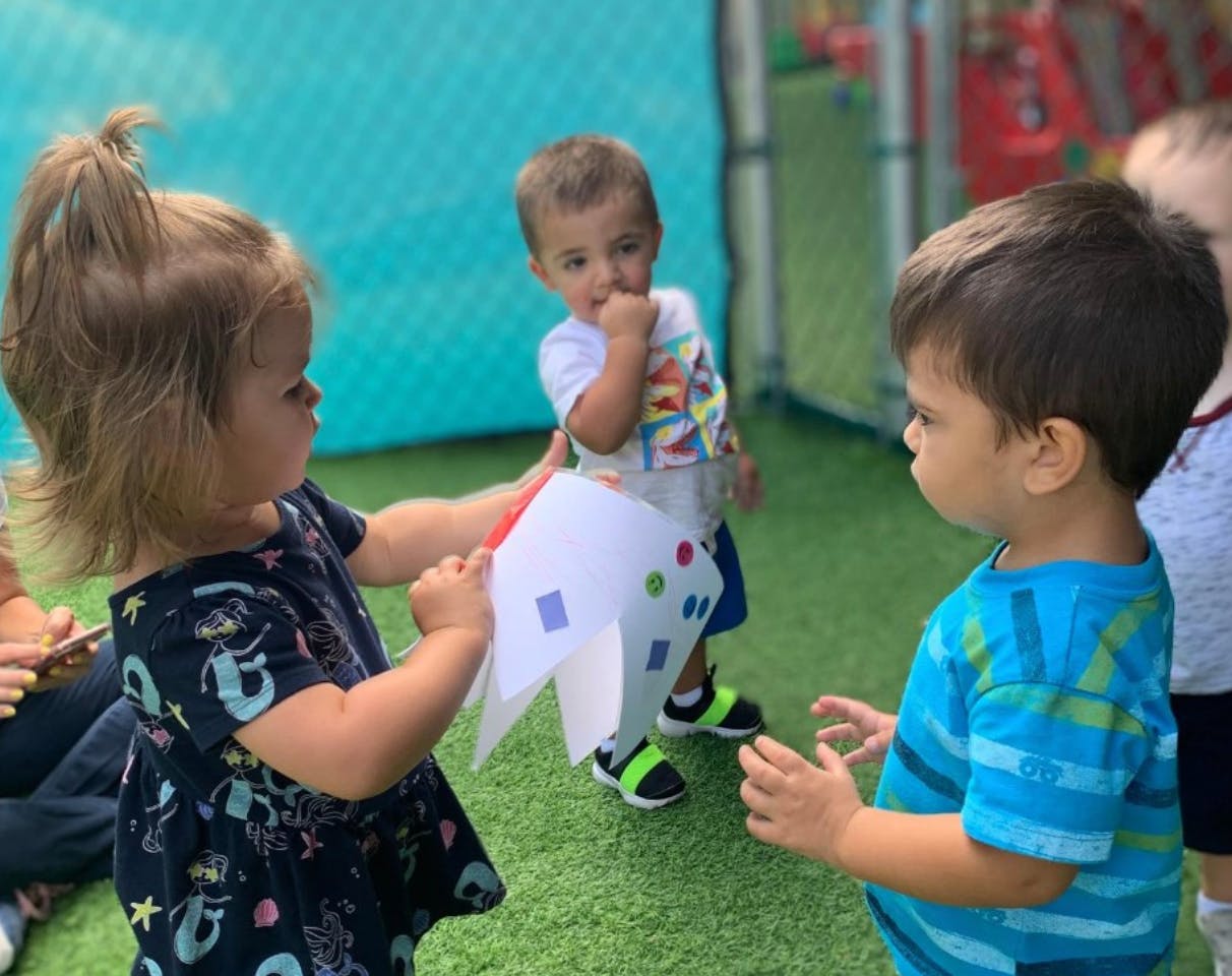 Three children playing outdoors