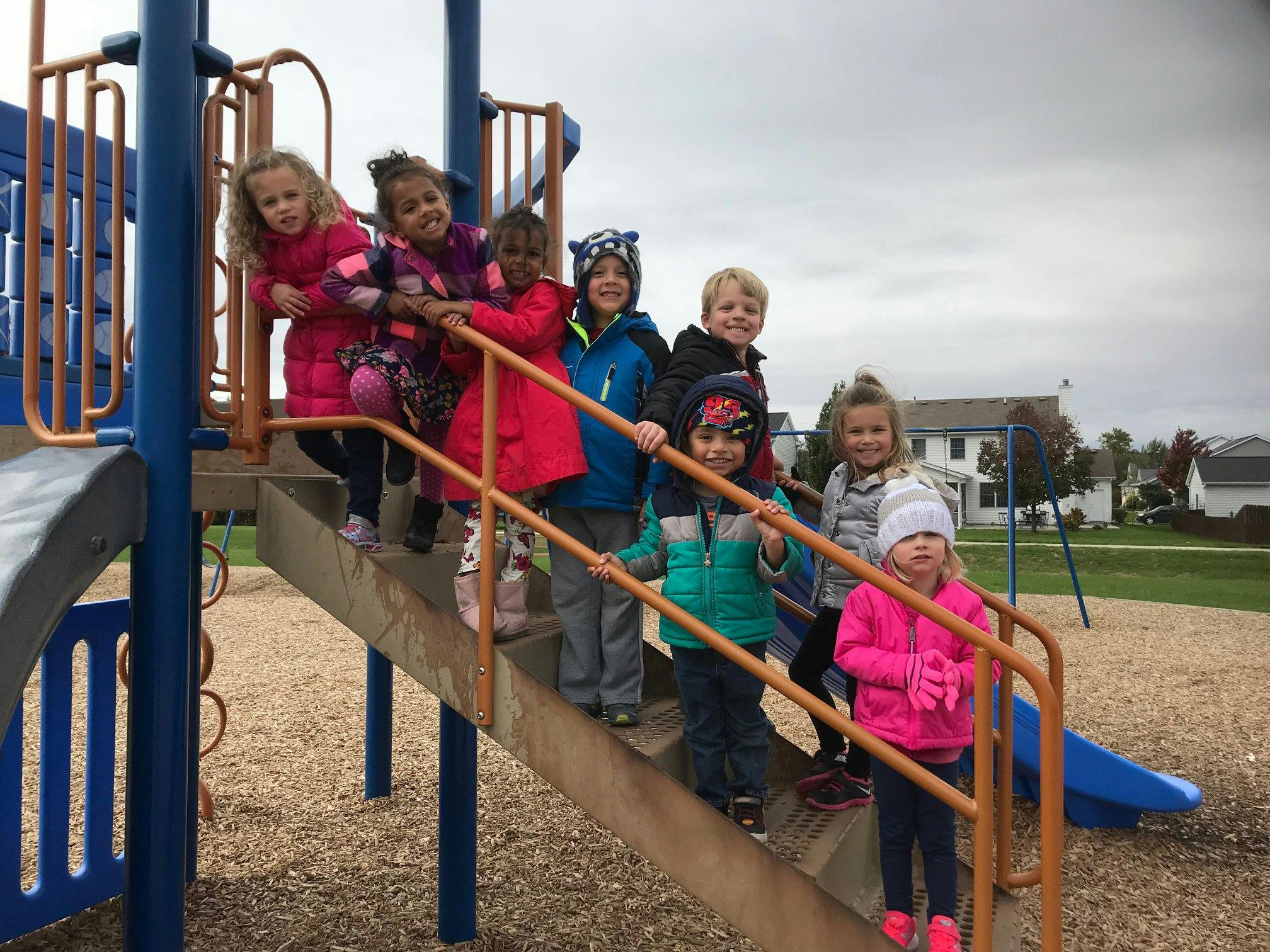 Group of children standing on playground stairs