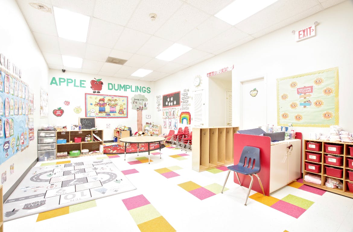 Empty classroom with colorful floor tiles and wall decorations