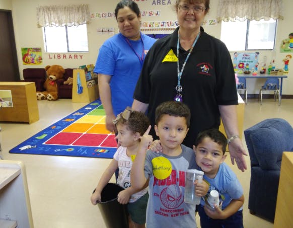 Two adults and three children in a classroom