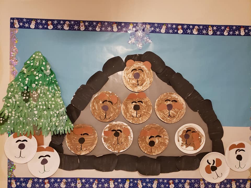 Craft display with a green tree and a brown house shape with bear faces