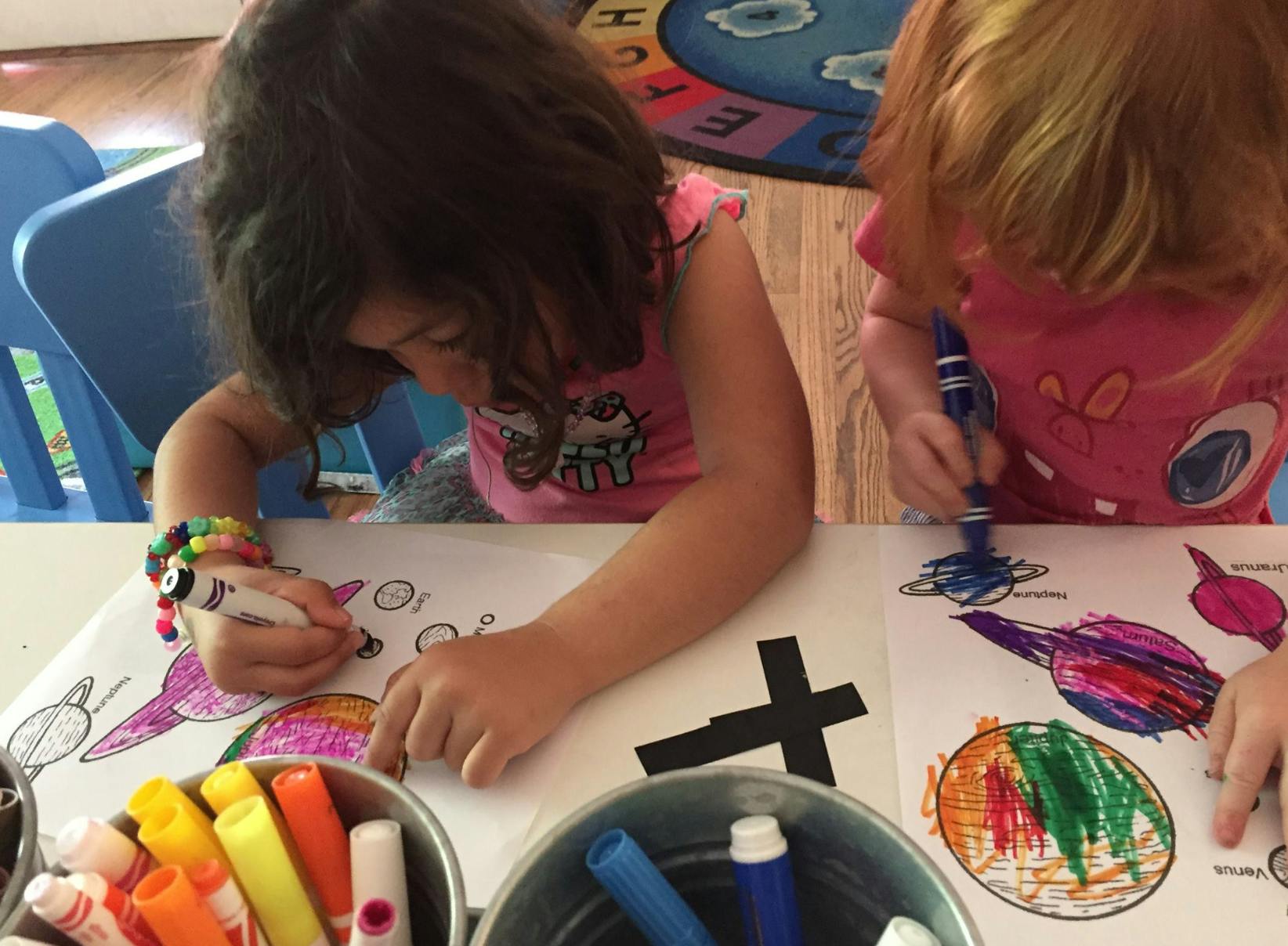 Two children coloring at a table