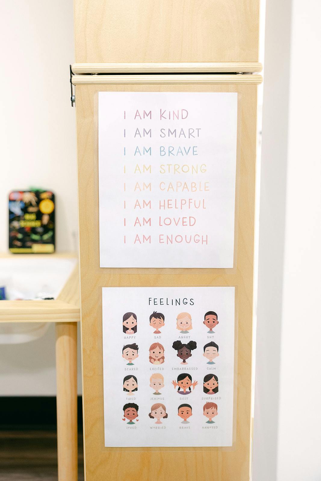 Close-up of a wooden easel with affirmation and feelings charts