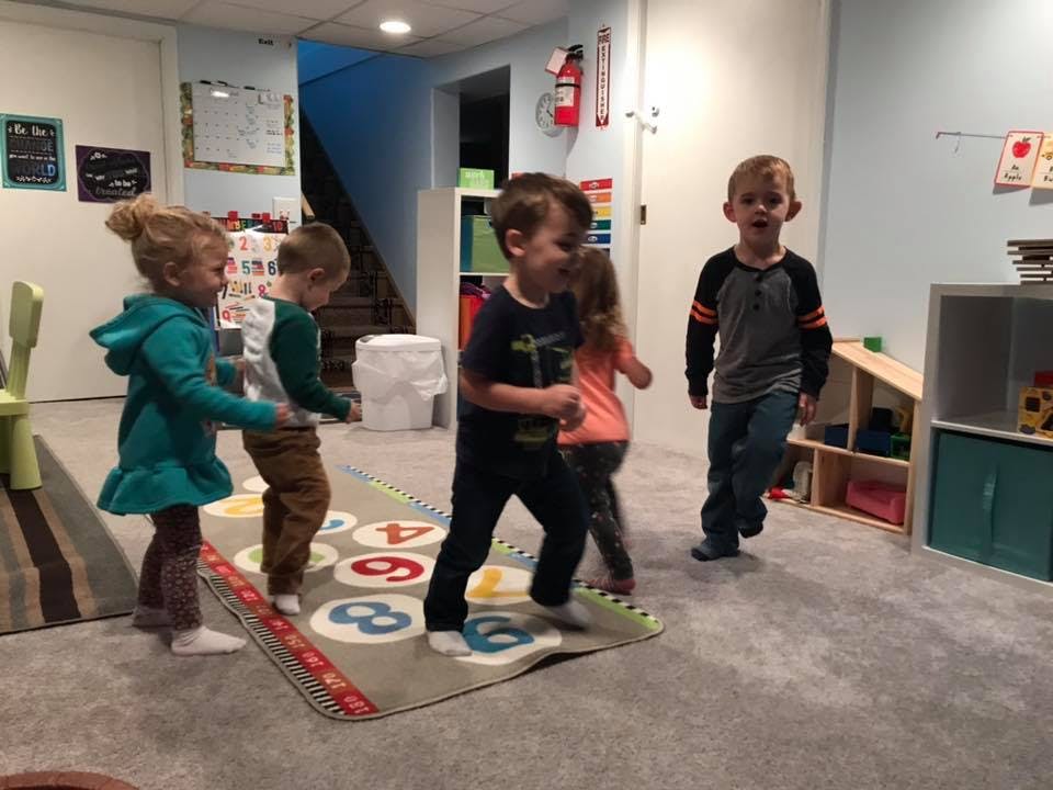 Children playing on a number mat