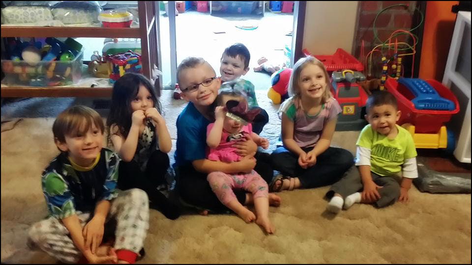 Group of children sitting on a carpeted