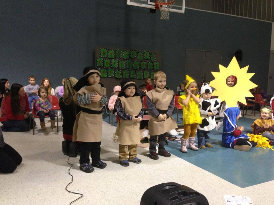 Children in costumes performing on a stage
