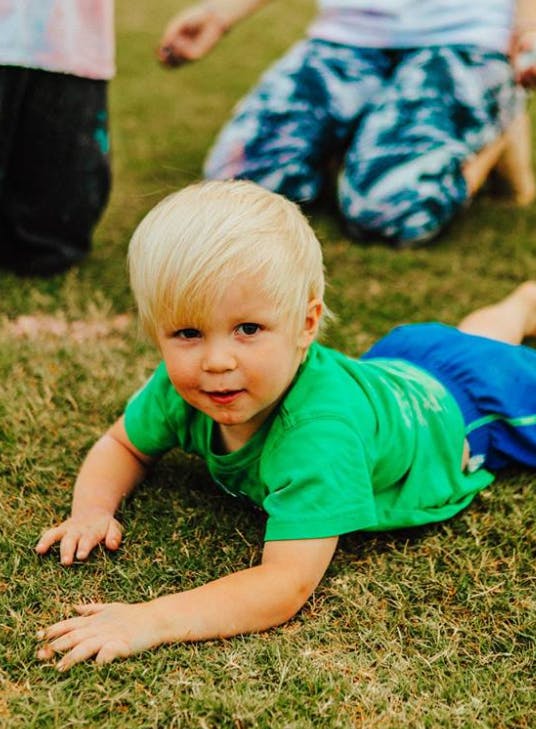 Child crawling on grass