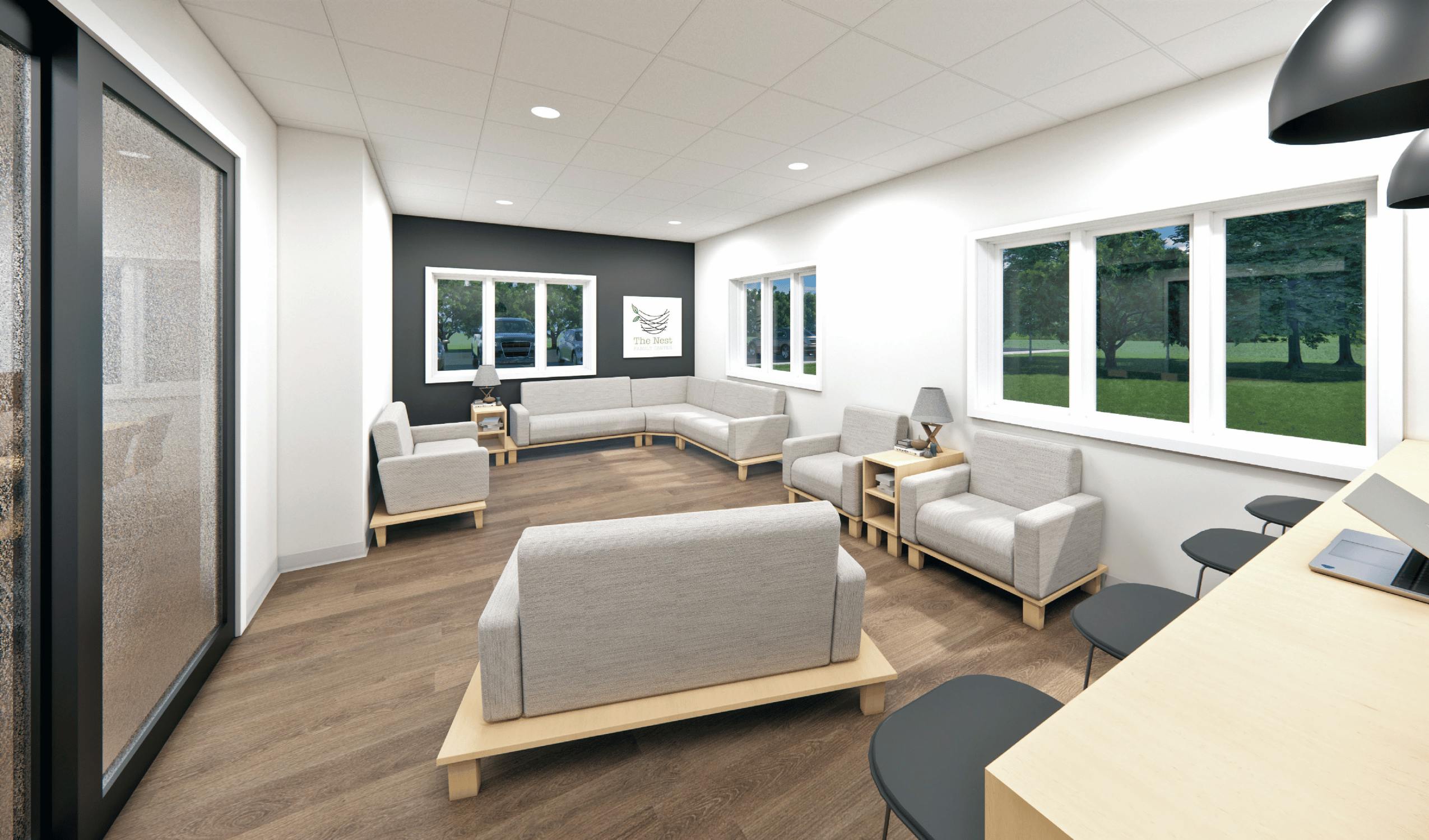 Lounge area with multiple sofas and armchairs, large windows, and a counter