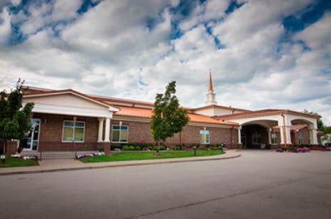 Building with a steeple and a drive-through entrance