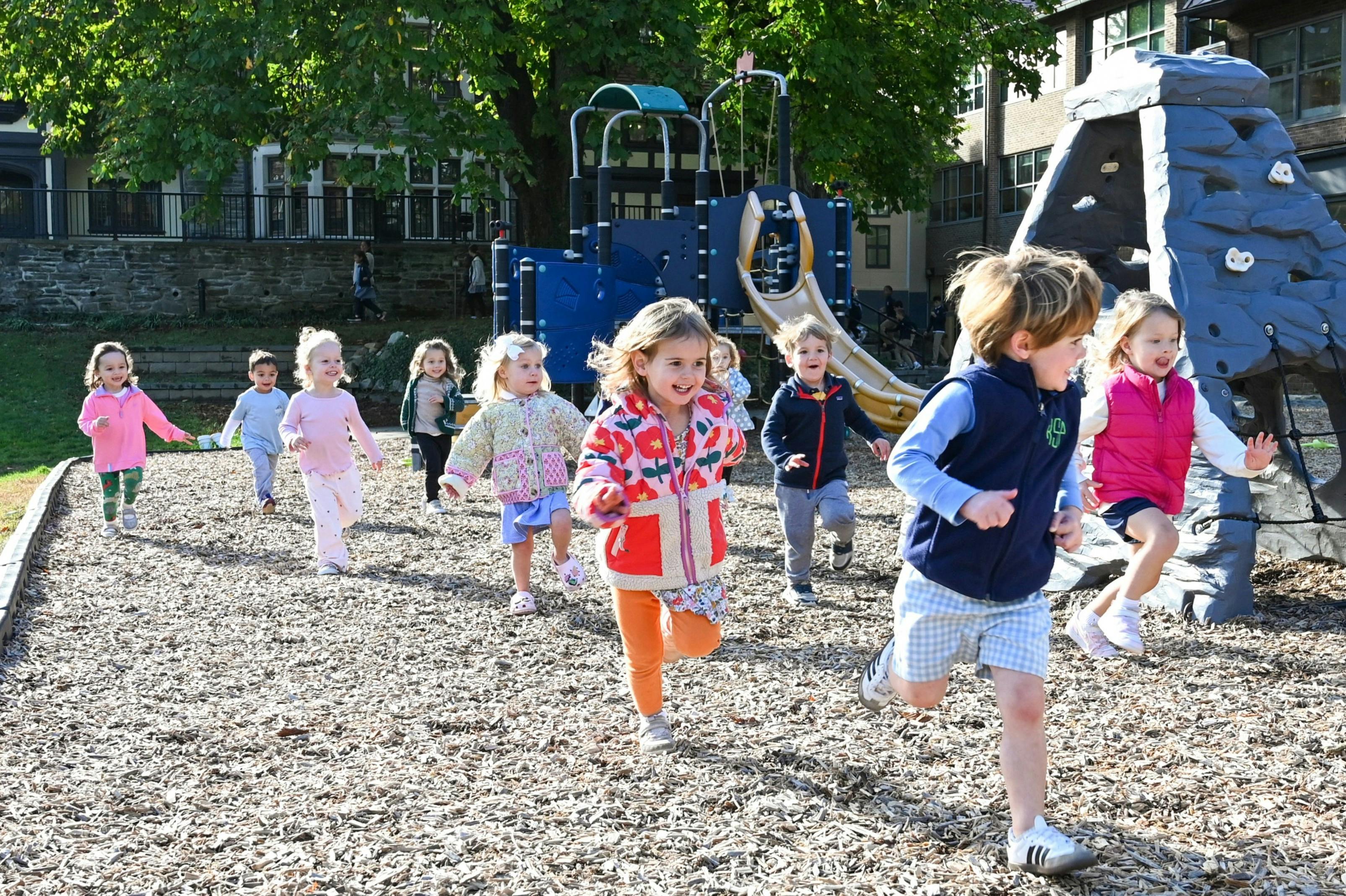 Group of children running across a playground