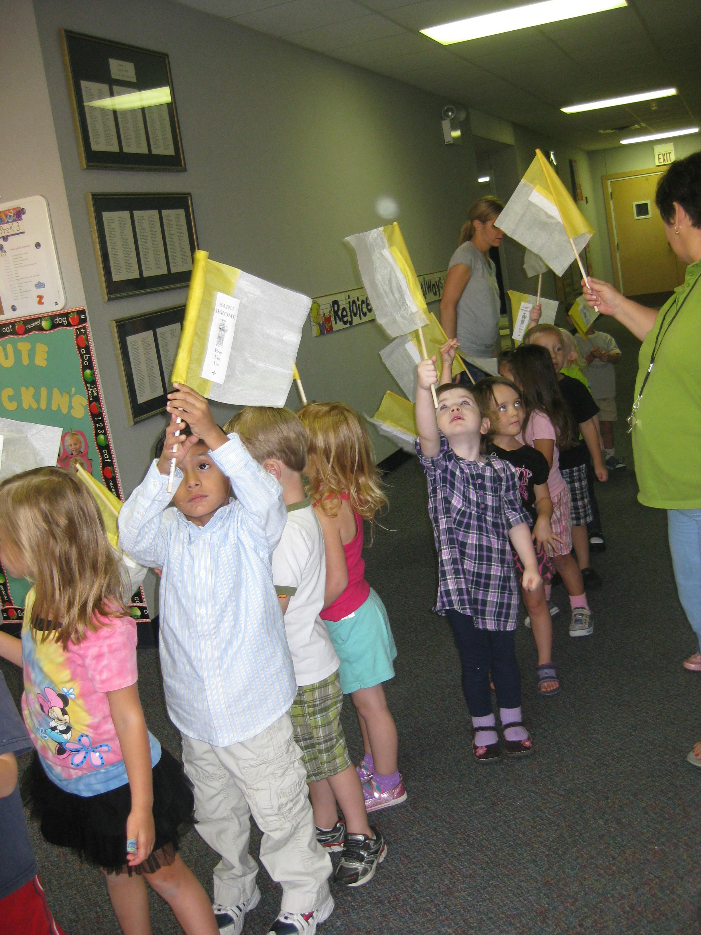 Children in a line holding small flags