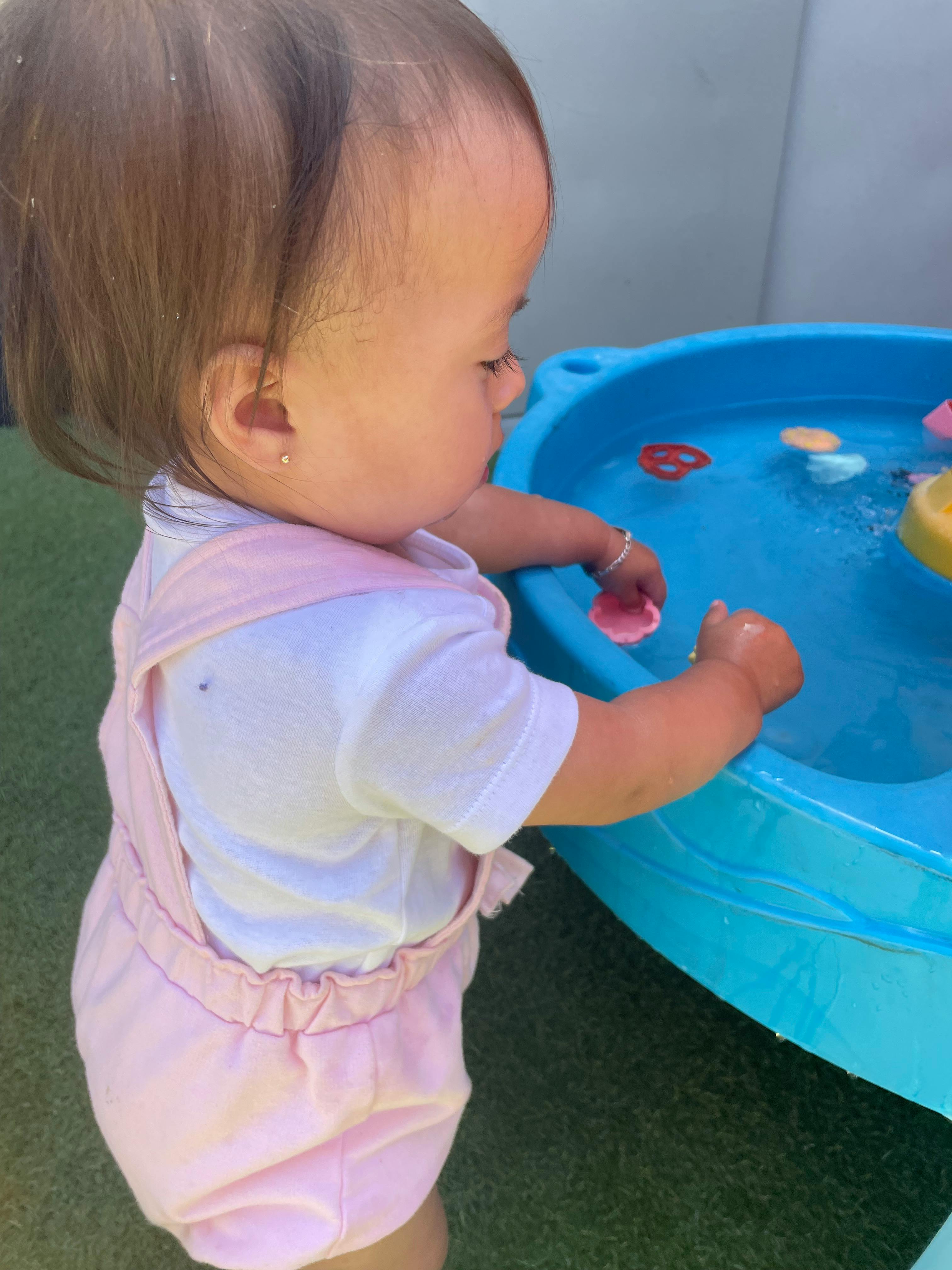 Child playing with water table
