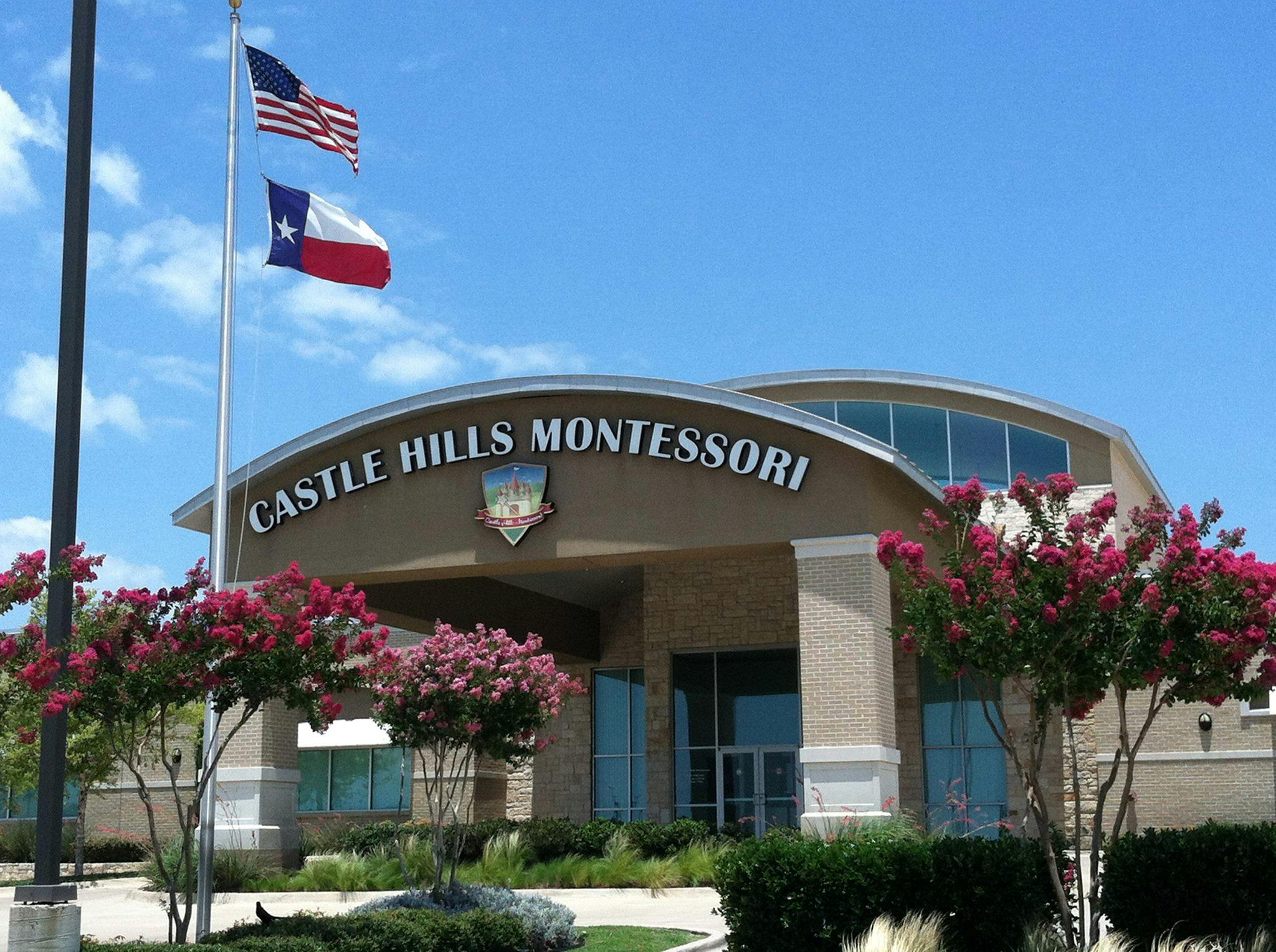 Castle Hills Montessori building with US and Texas flags