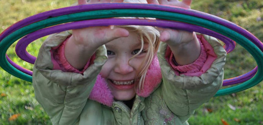 Child playing with multiple hula hoops