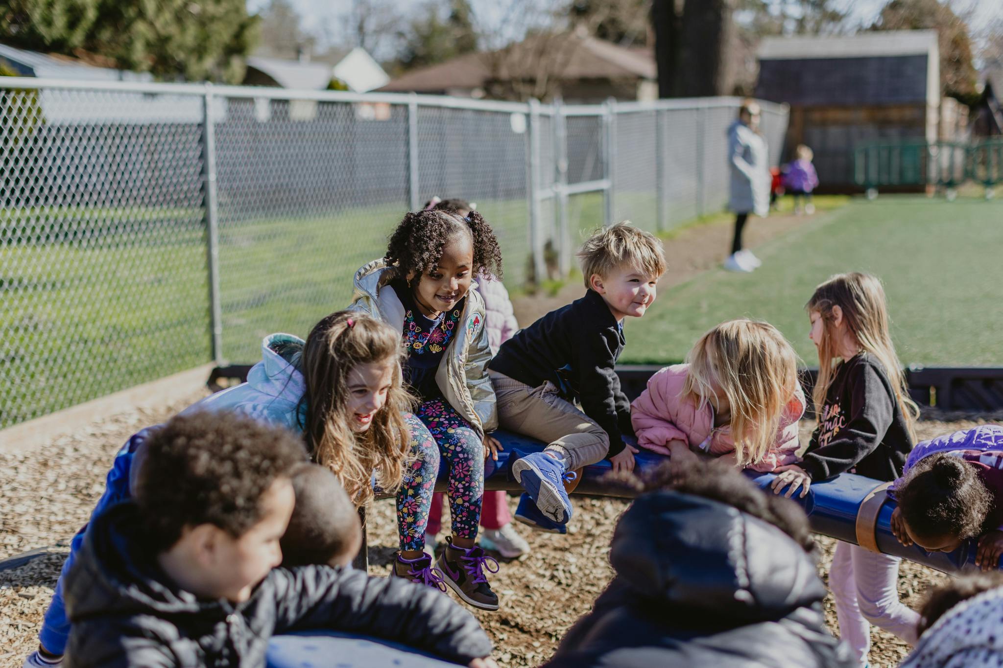 Children playing on a seesaw at a playground