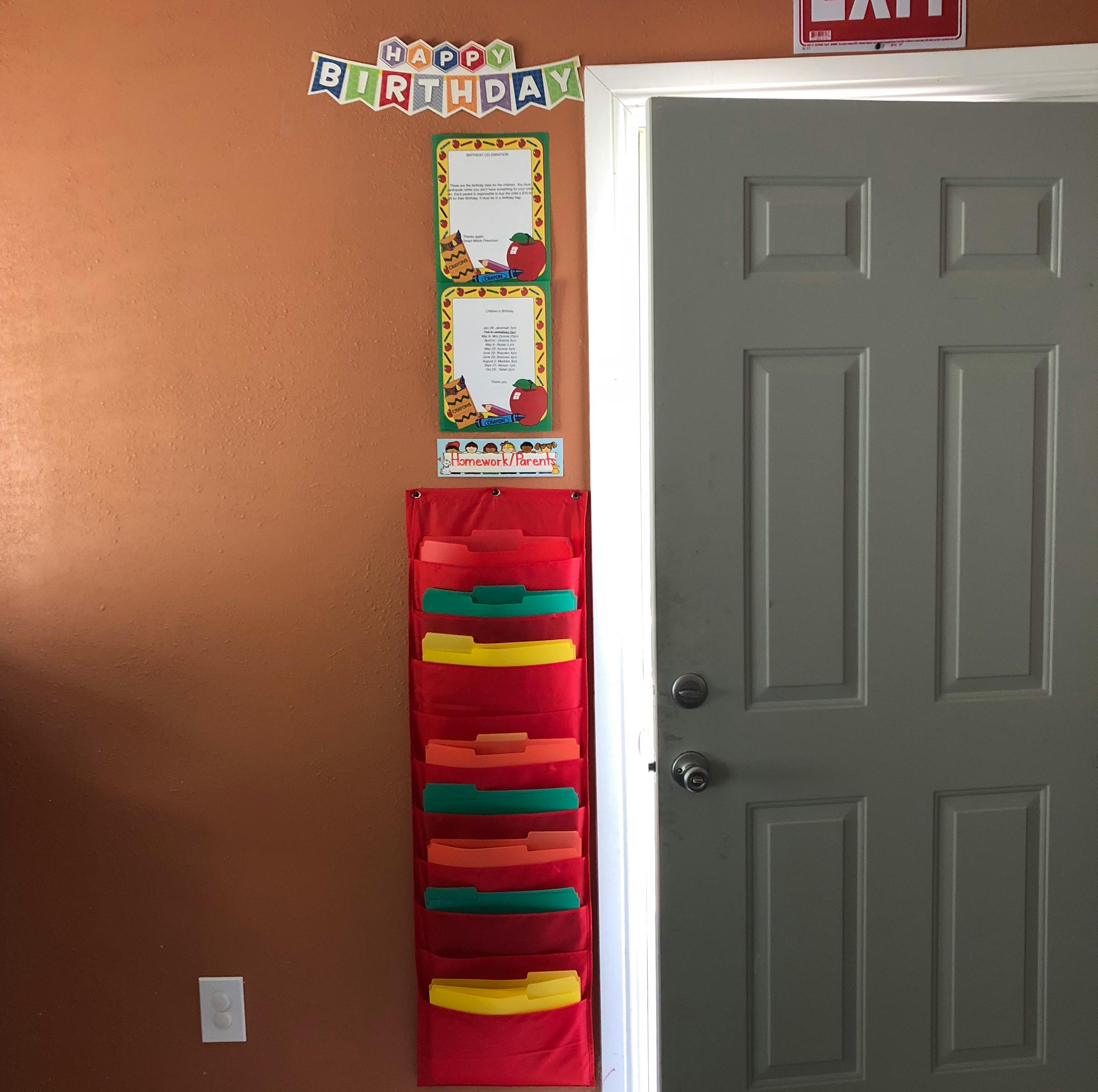 Happy Birthday banner above a red hanging file organizer next to a door