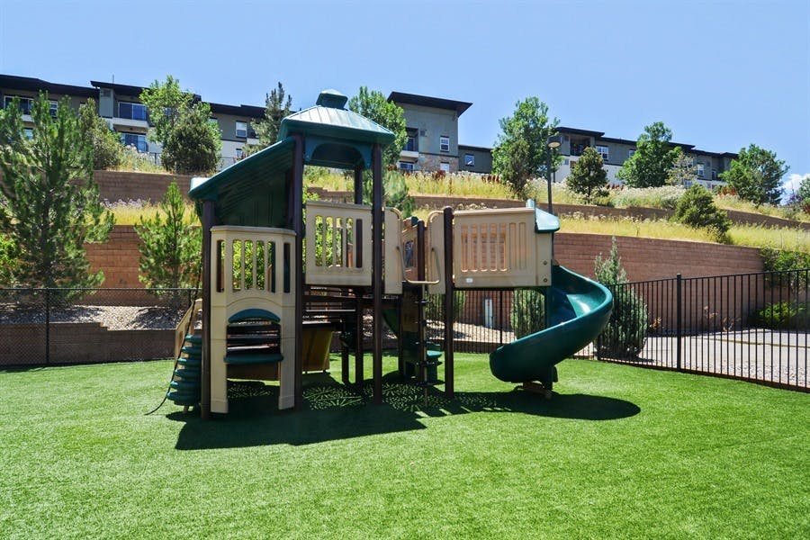 Playground with slides and climbing structures on green turf