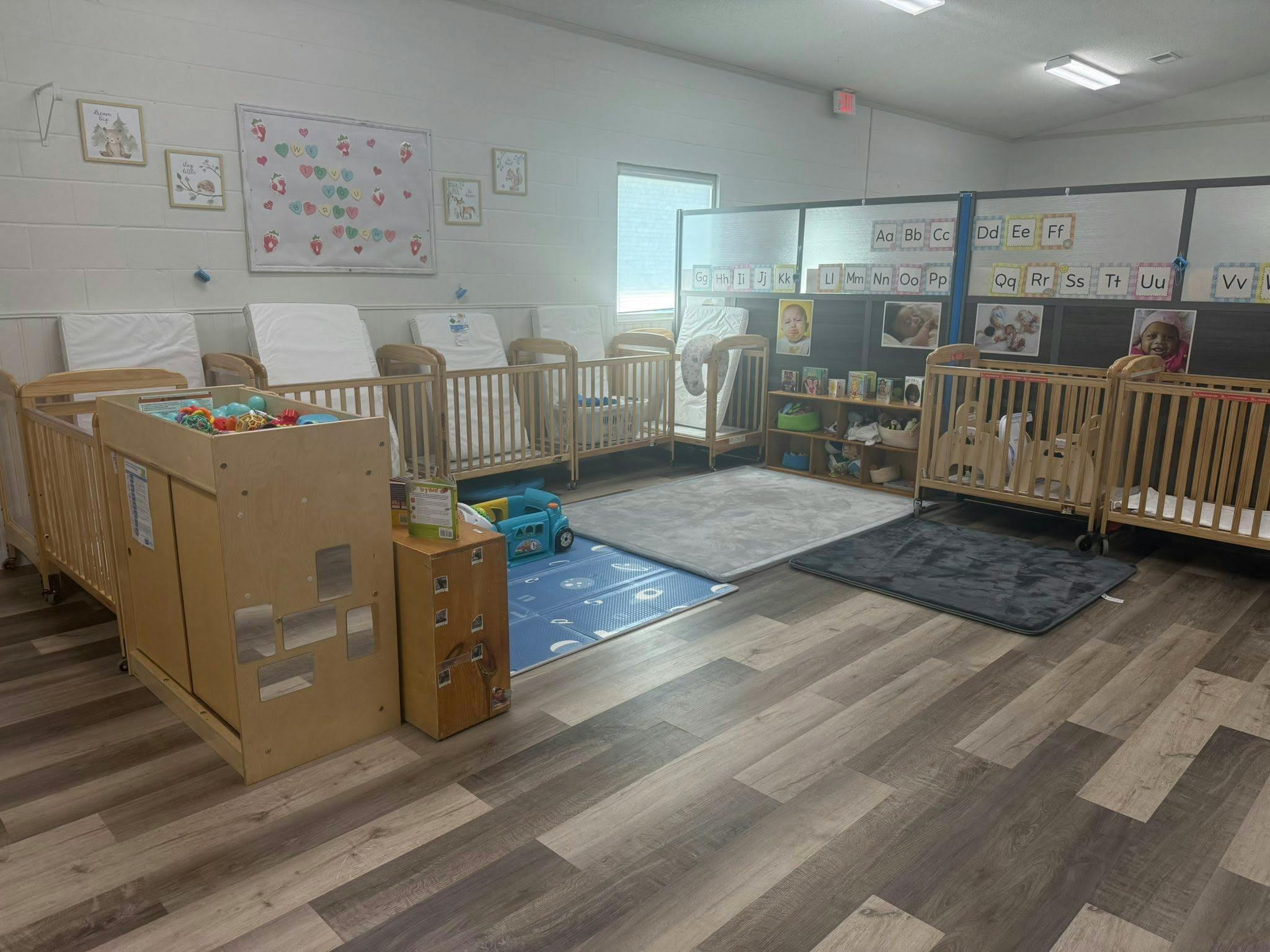 An empty nursery with multiple wooden cribs