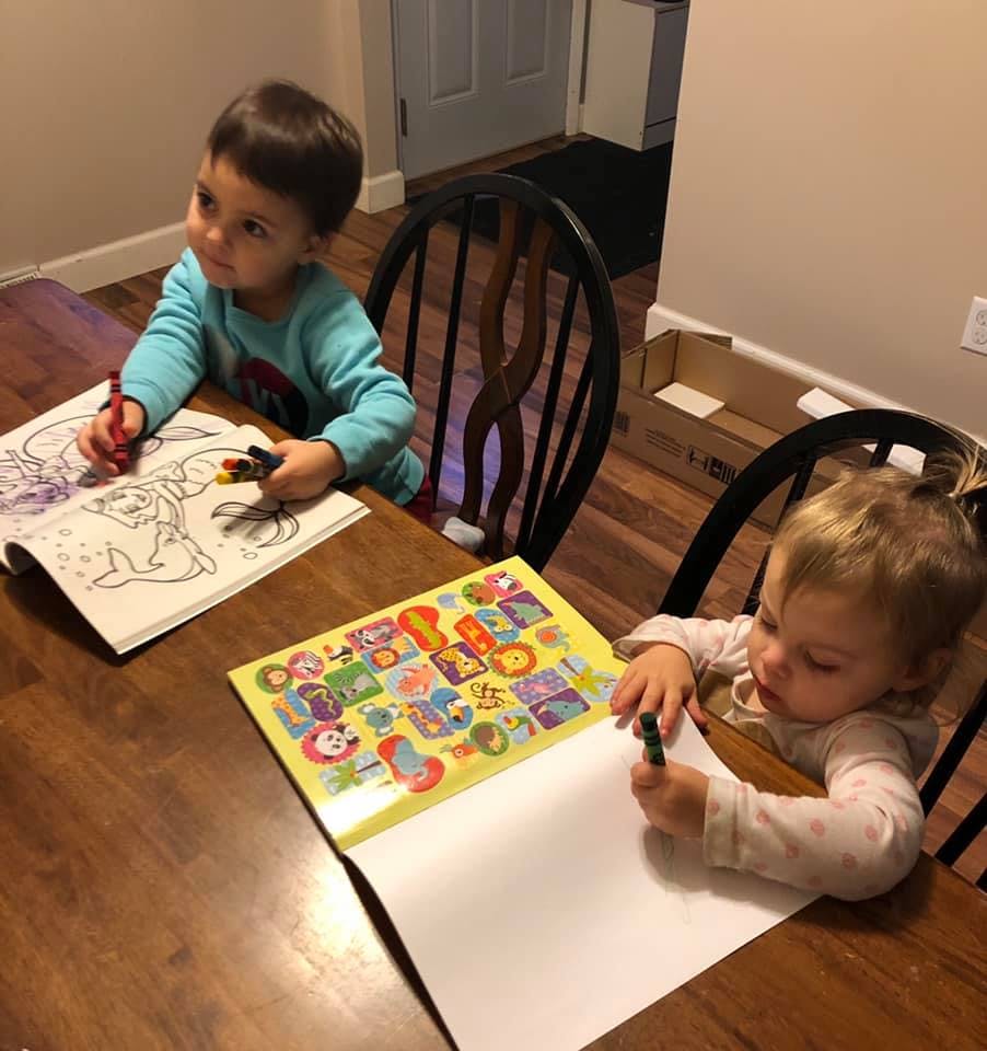Two children coloring at a table