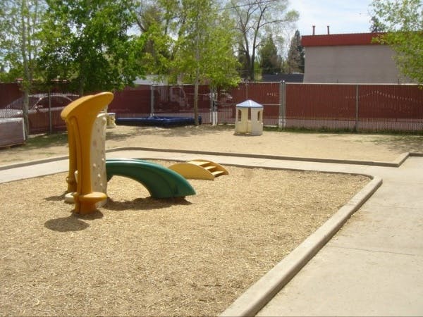 Playground with a slide and steps on wood chips
