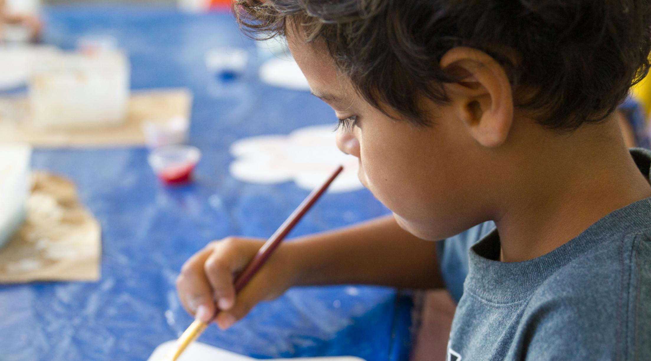 Child painting with a brush