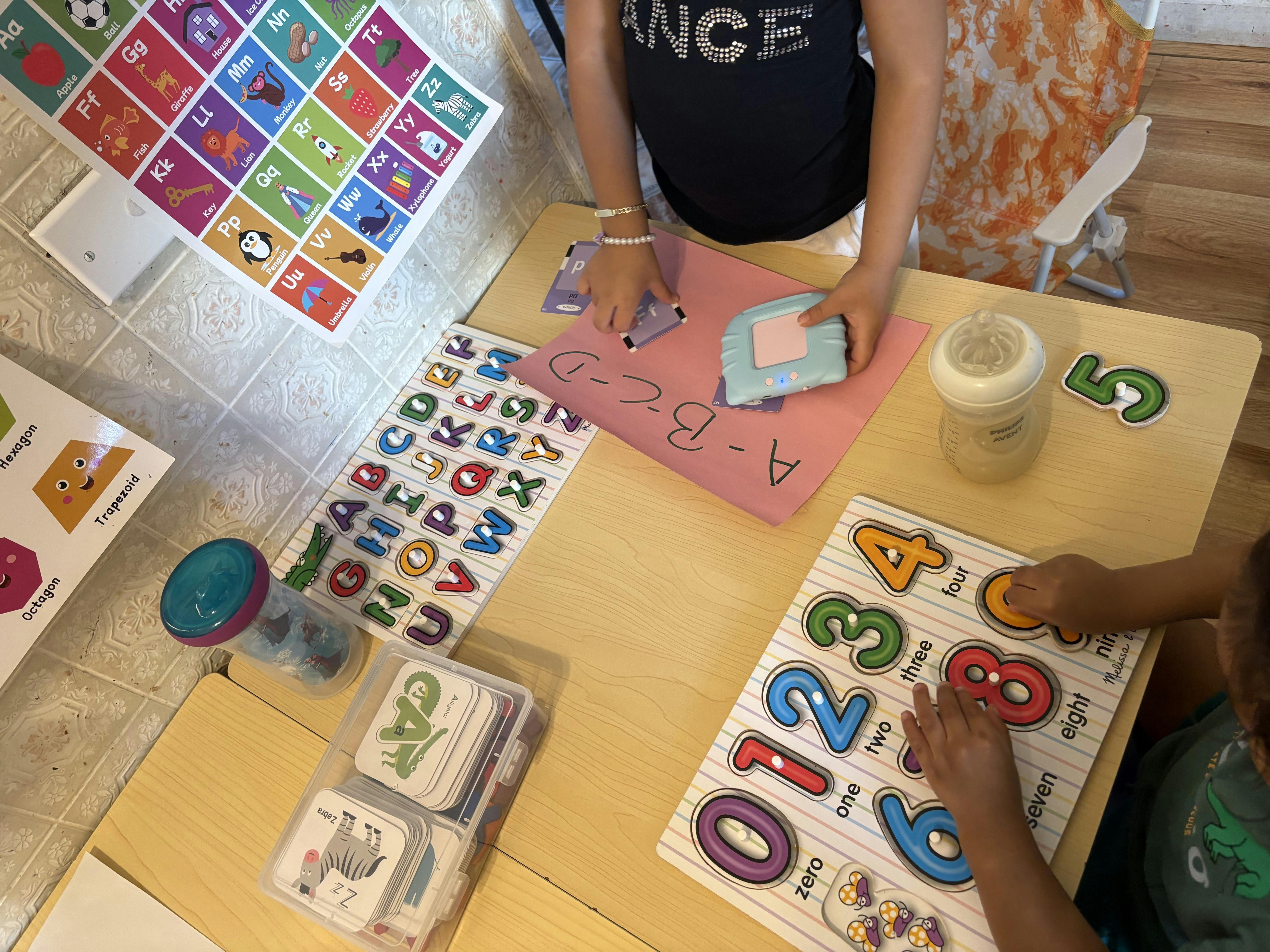 two children playing with educational toys on a table