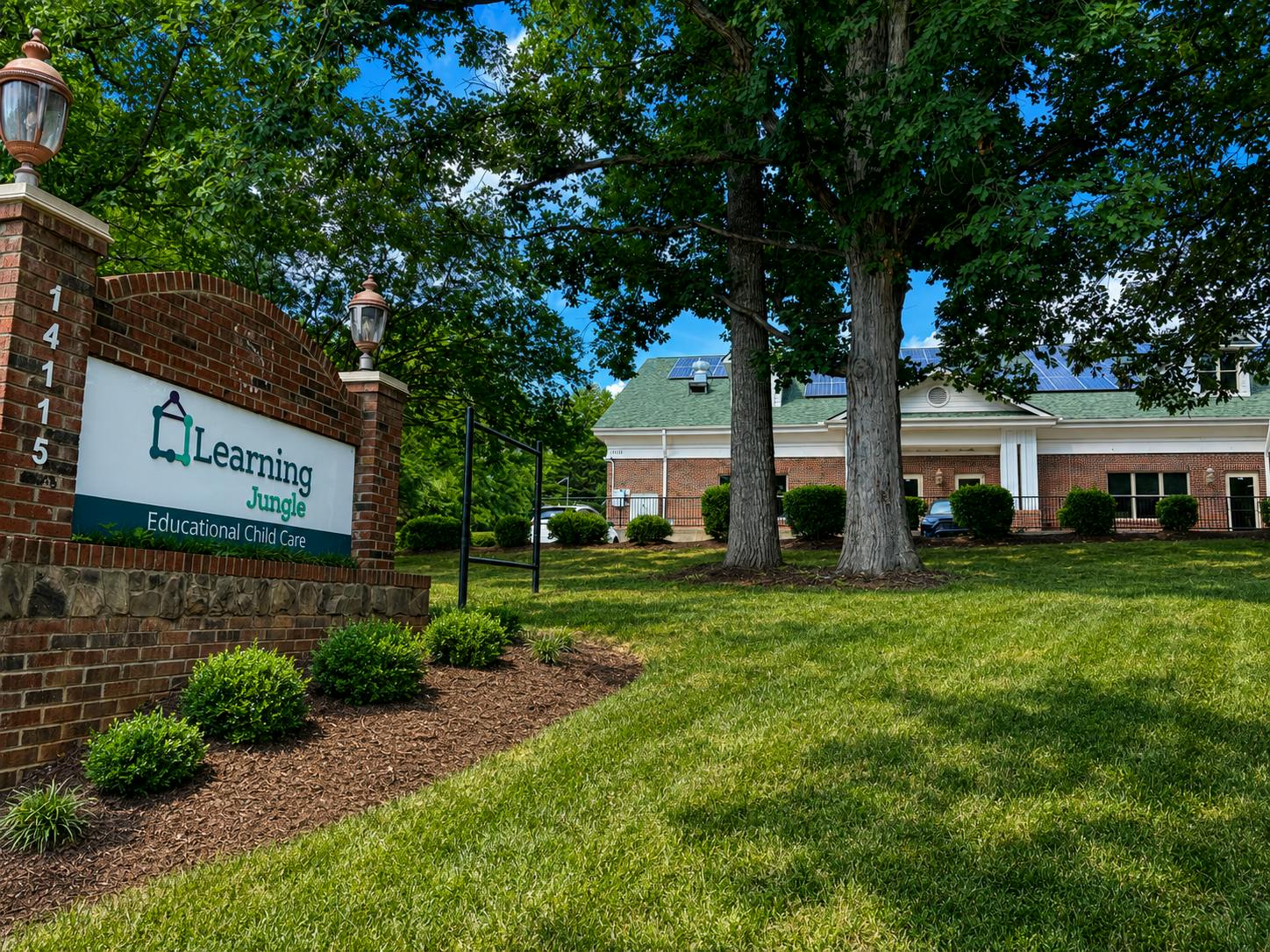 Sign for Learning Jungle Educational Child Care building in a grassy yard