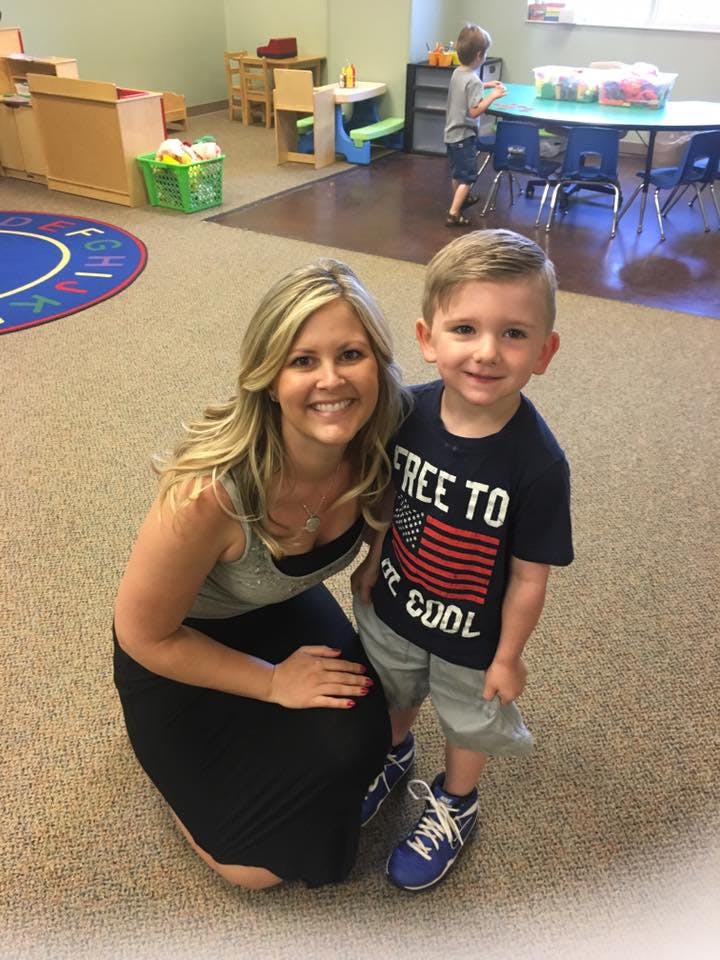 Adult and child posing in a classroom