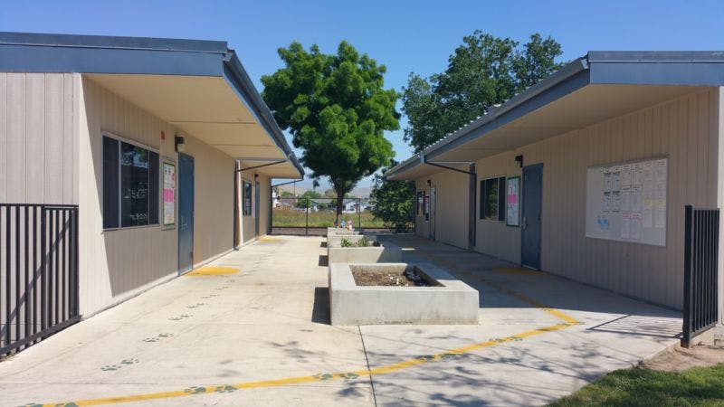 Two portable buildings with a walkway between them